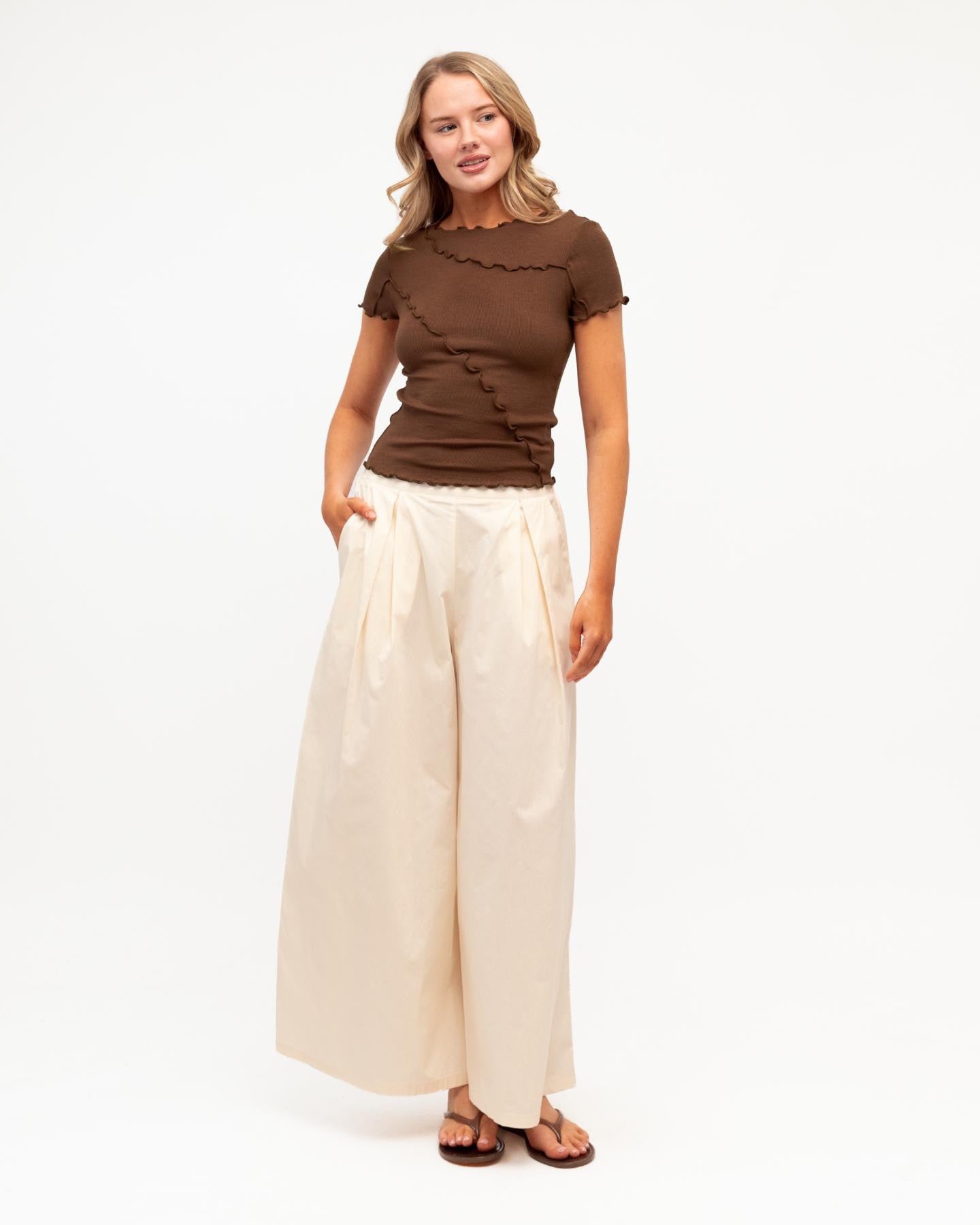 Sita Tee in chocolate - side view showing fitted silhouette