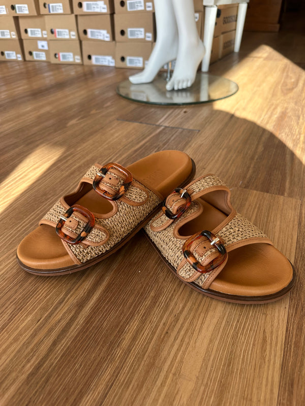 Luna Sole Eva slide in coconut, natural woven raffia straps with two oversized tortoiseshell buckles on a tan leather footbed
