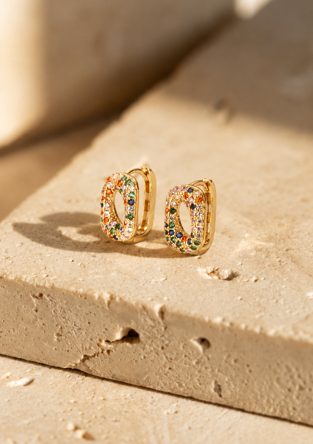 Confetti gold huggie earrings with rainbow cubic zirconia pave by Salt & Tide Co