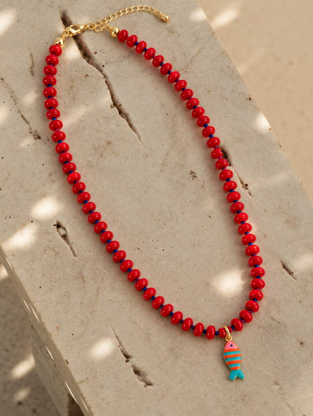Seaside red glass bead necklace with striped enamel fish charm by Salt & Tide Co