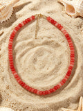 Sandbar coral red glass beaded necklace with gold tone clasp by Salt & Tide Co