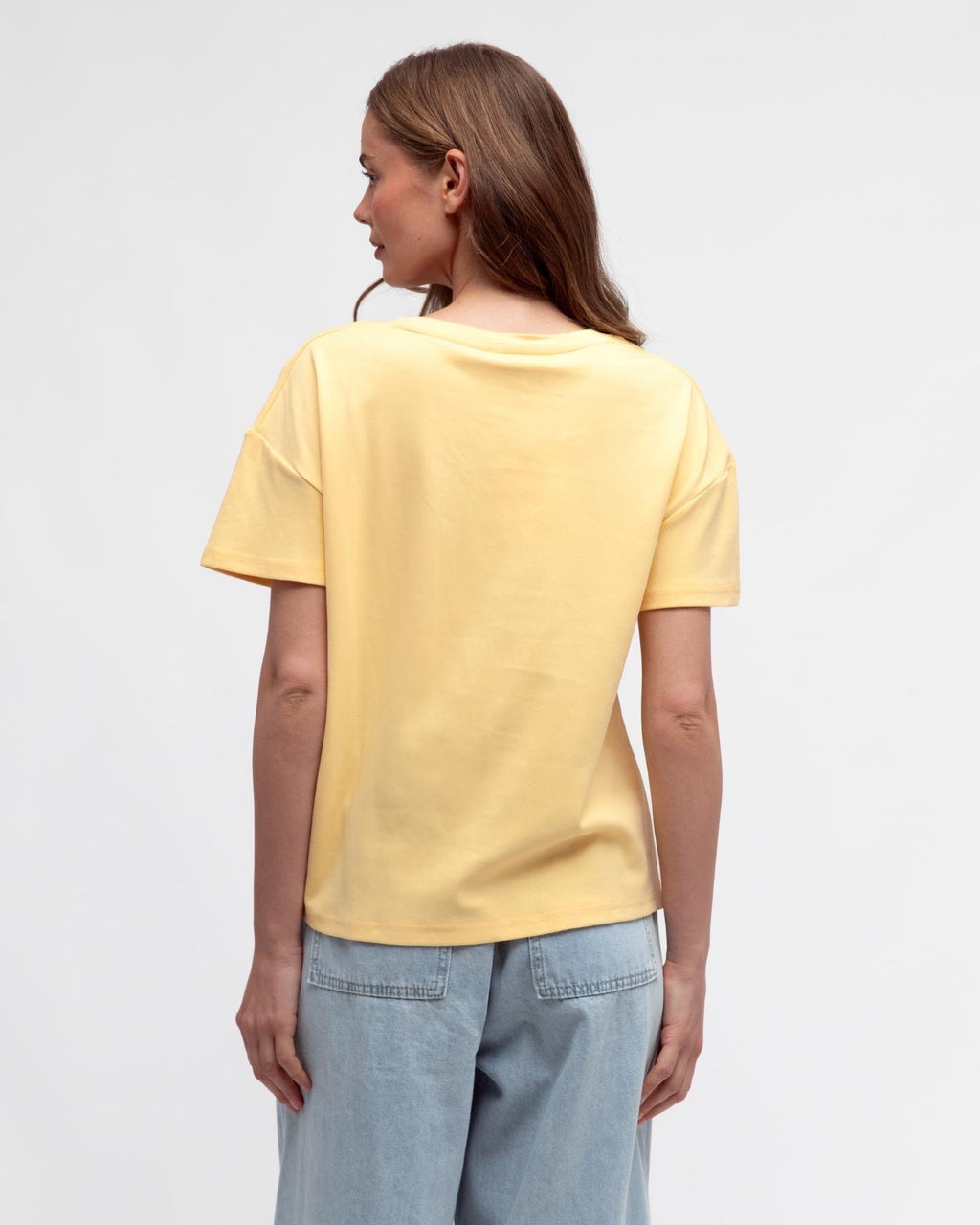 Easy Tuck Tee in Butter Yellow styled with denim - back view