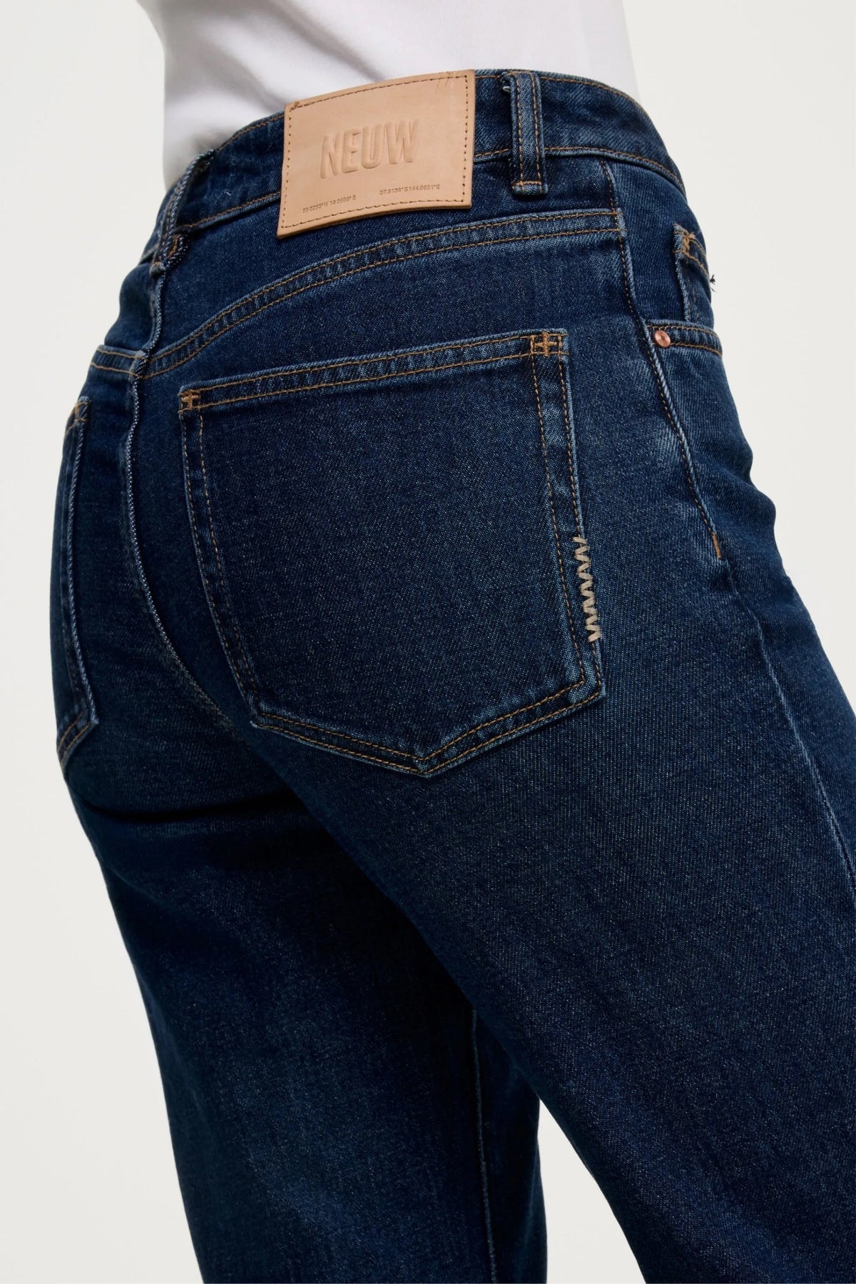 NEUW Freja Straight Jean in Brooding with antique silver shank button, rivets and signature repair stitch