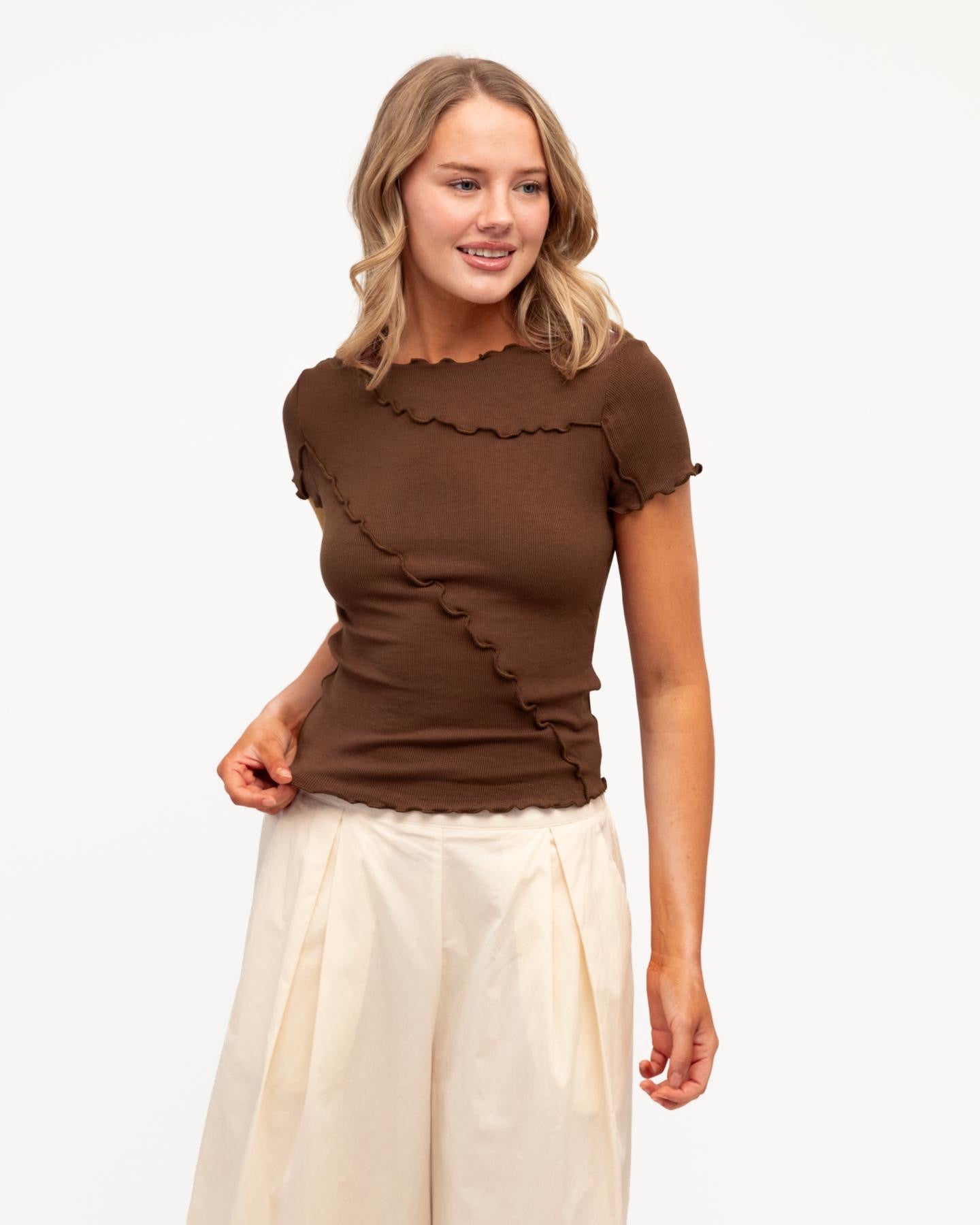 Sita Tee in chocolate - front view, ribbed cotton with asymmetrical seam detail